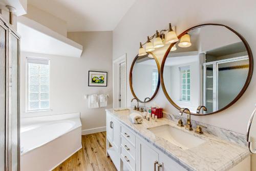a bathroom with two sinks and a large mirror at Lush Leisure - 816 Twenty Third Ave in Vero Beach