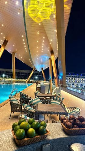 a room with tables and chairs and a pool on a cruise ship at Toàn Cầu Hotel Quảng Bình in Dong Hoi