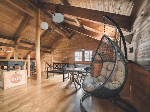 a room with a swing hanging from the ceiling at #65 Stella 八ヶ岳姫木平 in Tateshina