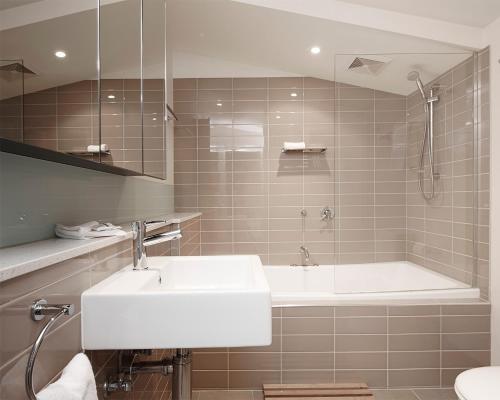 a bathroom with a sink and a bath tub at Apartment K2 15 AMS Mt Buller in Mount Buller