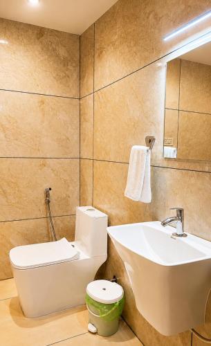 a bathroom with a toilet and a sink at Heaven Suite in Kalpetta