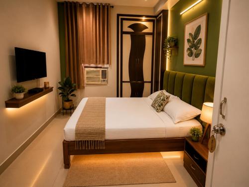 a small bedroom with a bed and a television at Hotel Viraat Inn Gaya in Gaya