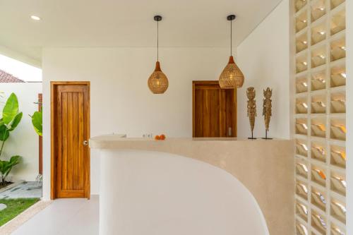 a kitchen with pendant lights and a counter at SUMA Bali in Uluwatu