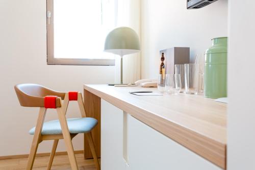 a room with a counter with a chair and wine glasses at Casa Burano in Burano