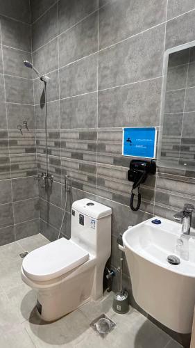 a bathroom with a toilet and a sink at الربوه سويت in Jeddah