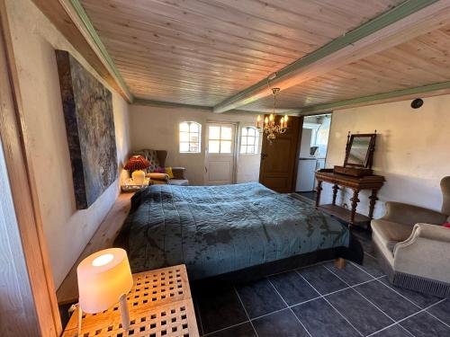 a bedroom with a large bed in a room at Cozy Older Property On Ærø in Søby