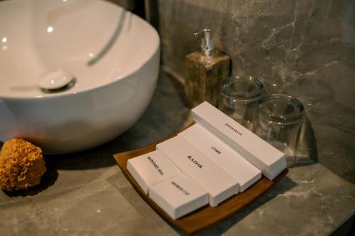 a bathroom counter with a sink and a white bowl at Arcana Ubud in Ubud