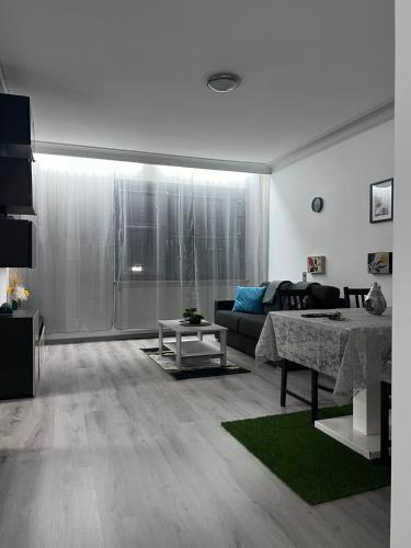 a living room with a couch and a table at Modernes City Apartment 8km Red Bull Ring in Knittelfeld