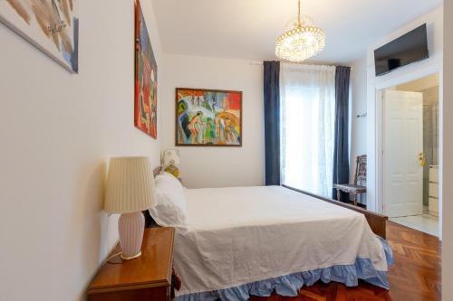 a bedroom with a bed and a lamp and a window at Casa Bianca in Silvi Marina