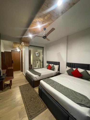 a hotel room with two beds and a dining room at Apurwa Grand Resort in Baragrān