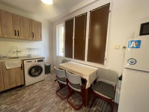 a kitchen with a table and chairs and a refrigerator at Къща за гости САРАЯ Ретро стил in Svishtov
