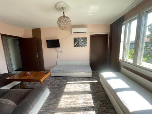 a living room with a bed and a couch at Къща за гости САРАЯ Ретро стил in Svishtov