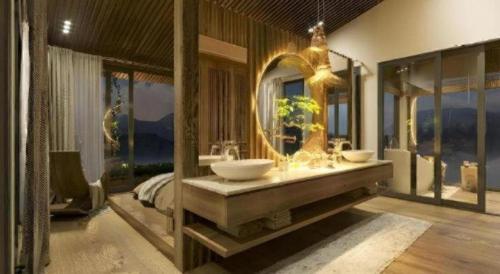 a bathroom with two sinks and a large mirror at Viettrekking Sapa in Lo Sui Tong