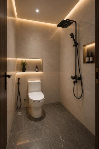a bathroom with a toilet and a shower at Chenz Guest House in Ancol