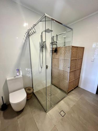 a bathroom with a glass shower and a toilet at Mountain View Blue Mountains in Kurrajong