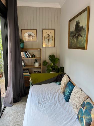 a bedroom with a bed and a book shelf at Mountain View Blue Mountains in Kurrajong