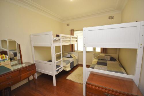 a bedroom with a bunk bed and a mirror at 13 High Street in Nambucca Heads