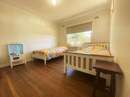 a bedroom with two beds and a tv in it at 10 Clarke in Nambucca
