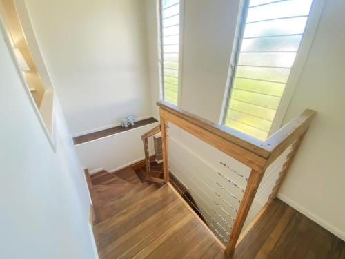 a staircase with a window and a wooden floor at 10 Clarke in Nambucca