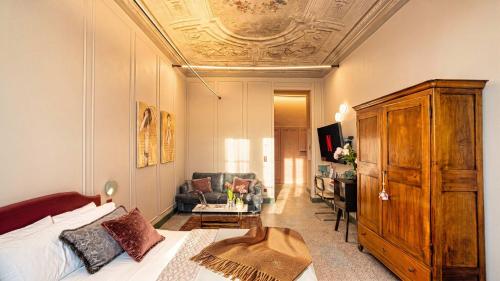 a bedroom with a bed and a living room at Homeby, Cinisca Suite Rose in Bologna