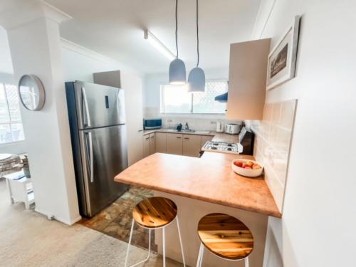 a kitchen with a counter and a refrigerator at 59 Short in Nambucca Heads