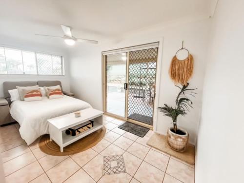 a bedroom with a bed and a table at 59 Short in Nambucca Heads