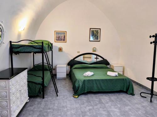a bedroom with two bunk beds and a mirror at Holiday Residence in Casamassima