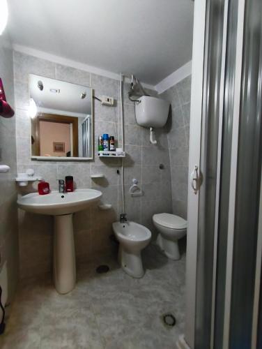 a bathroom with a sink and a toilet and a mirror at Holiday Residence in Casamassima
