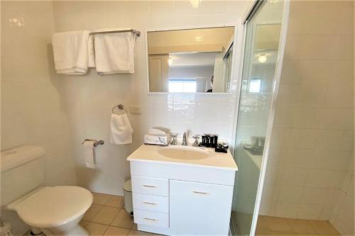 a bathroom with a toilet and a sink and a shower at Estuary in Nambucca Heads