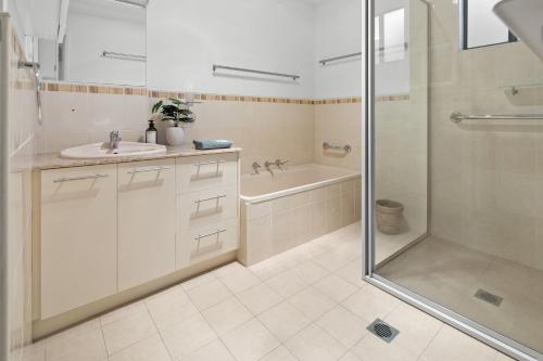 a bathroom with a shower and a sink and a tub at Coastal Chill in Nambucca Heads