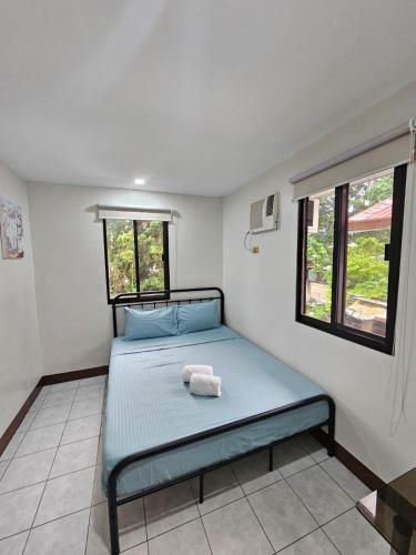 a bedroom with a bed with two towels on it at Kasa Boutique Residence in Cebu City