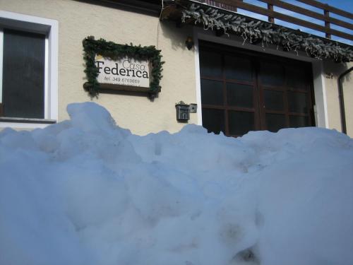 a pile of snow in front of a building at Residence Casa Federica in Valfurva