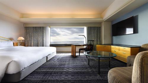 a hotel room with a bed and a desk and a window at Hotel New Otani Makuhari in Chiba