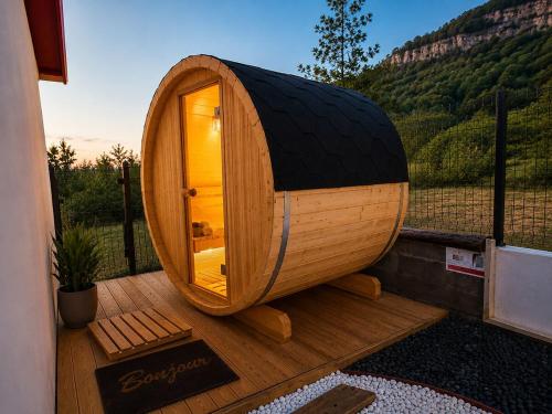 a round wooden sauna on a deck with a mountain at L'Eden du Piton des Roches in La Plaine des Palmistes