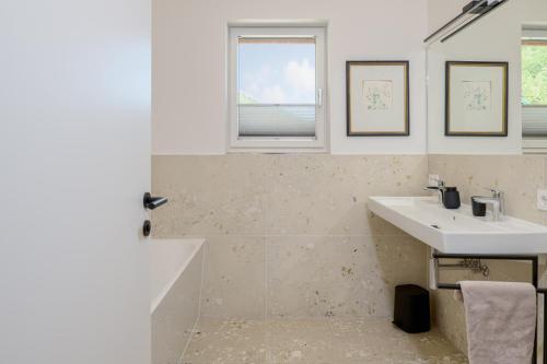 a bathroom with a sink and a mirror at Gratzenthal Boutique Apartments in Hollenstein an der Ybbs