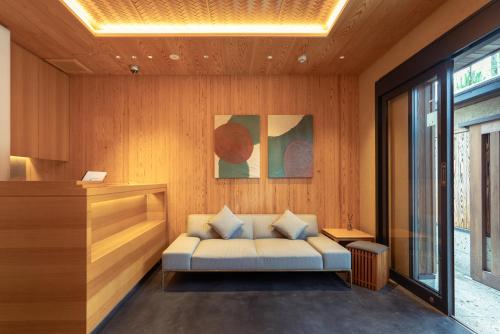 a living room with a couch in a room at MR T Kamogawa East 12 in Kyoto