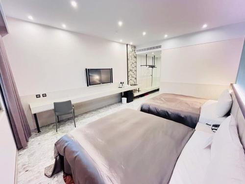 a hotel room with two beds and a flat screen tv at Region Motel in Lukang