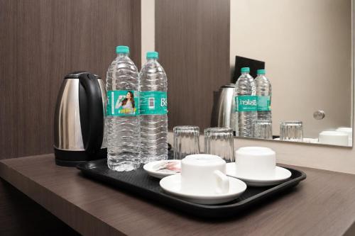 a tray with two bottles of water on a table at Vilasa Prime Hotel in Guwahati