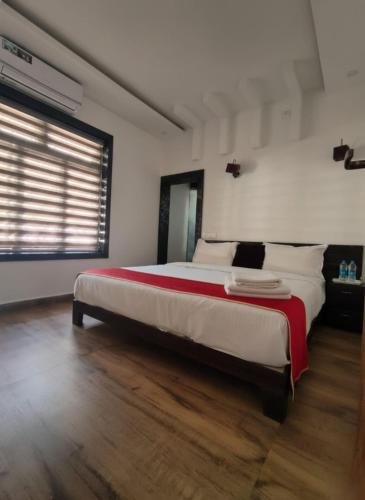 a bedroom with a large bed and a window at Forest edge Villa - 3 bedrooms in Ambalavayal