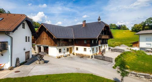 an aerial view of a large wooden house at Stadtbauernhof Salzburg - Ferienwohnung - Gut Unterleithen - farm & the city in Salzburg