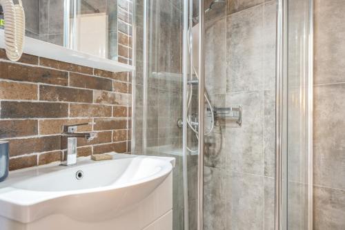 a bathroom with a sink and a shower at Hotel Albatros in Karpathos