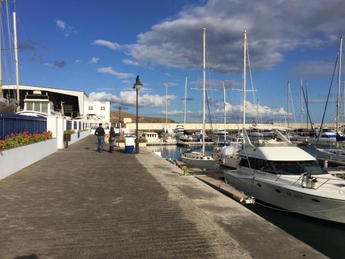 a group of boats docked at a marina at Puerto Calero Boat in Puerto Calero