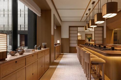a cafeteria with a long line of tables and benches at Capella Kyoto in Kyoto