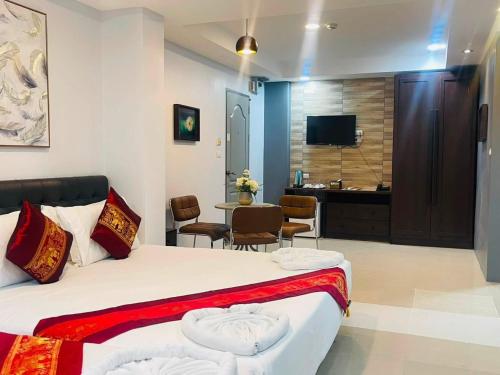 a hotel room with a bed and a table with chairs at Pongsakorn Boutique Resort in Lat Krabang