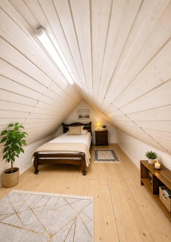 a bedroom with a bed in a white room at Вілла Смерекова хата in Kelechin