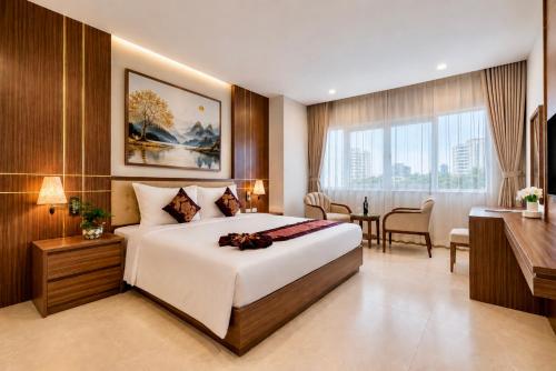a hotel room with a large bed and a desk at T78 Luxury Hotel in Ho Chi Minh City