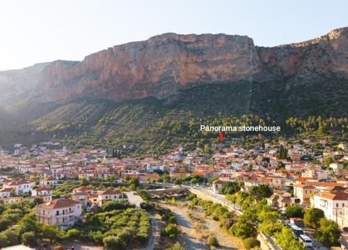 a view of a city with a mountain in the background at Panorama Stonehouse in Leonidio