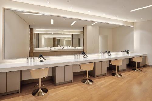 a bathroom with a long counter with a large mirror at Sheraton Grand Incheon Hotel in Incheon