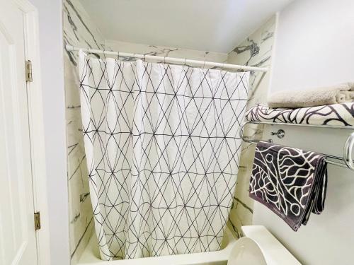 a bathroom with a shower curtain and a toilet at Hopes Cozy Condo in Phoenix