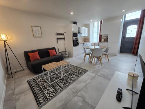 a living room with a couch and a table at Domaine de Zely in Fontaines-dʼOzillac